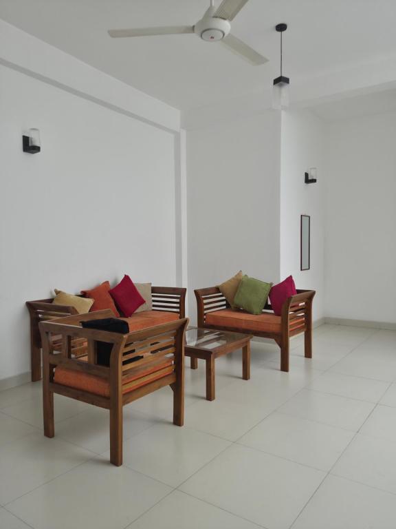 a group of chairs with pillows sitting in a room at Holiday Inn in Colombo