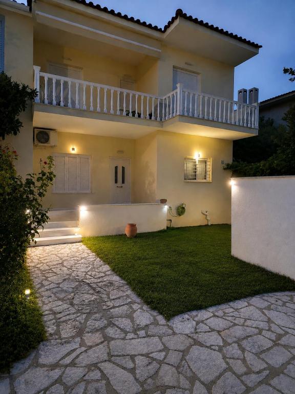 a large house with a lawn in front of it at ALIO Seaside Maisonette, Steps from Diakopto Beach in Diakopto