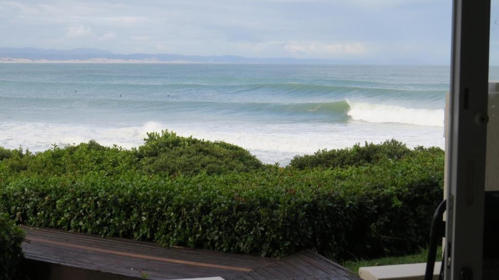 a view of the ocean from a house at At the Beach in Jeffreys Bay