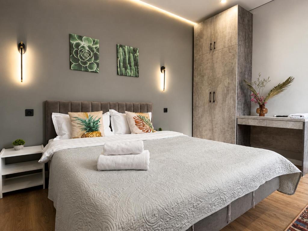 a bedroom with a large bed with white sheets and pillows at Nazarbayev avenue central studios in Almaty