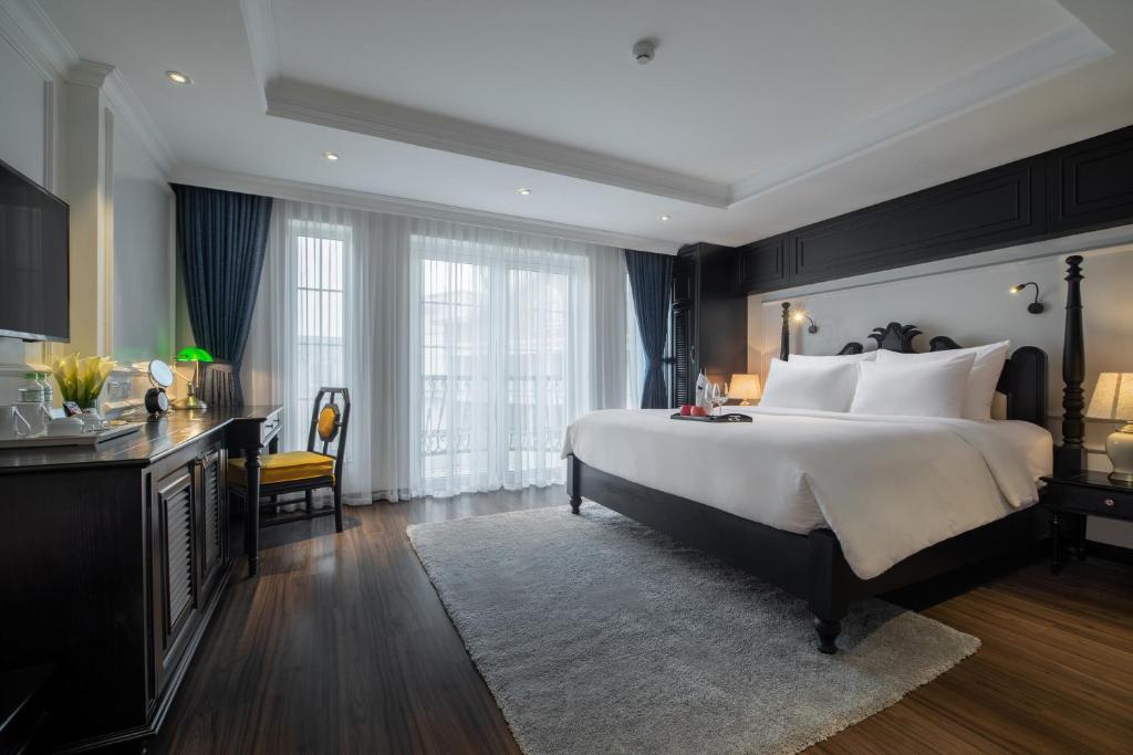 a bedroom with a large bed and a large window at Sapa Boutique Hotel & Spa in Sapa