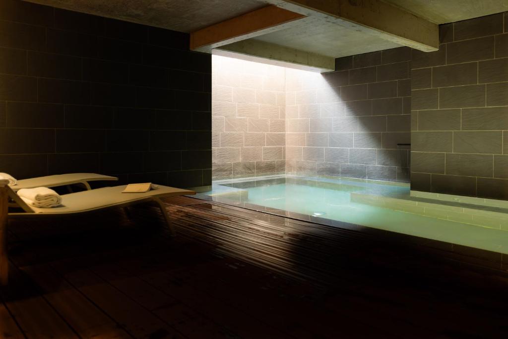 a bathroom with a bath tub with a light in it at 9Hotel Sablon in Brussels