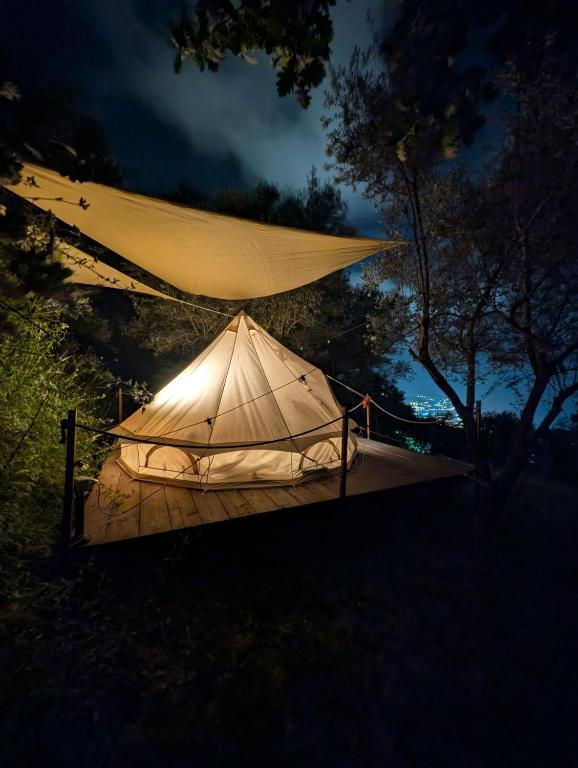 a tent is lit up at night at Habitat Eco Farm in Sorrento