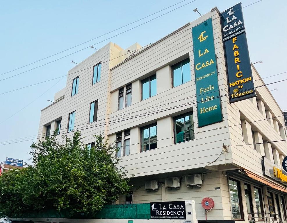 a building with a sign on the side of it at La Casa Residency in Lucknow