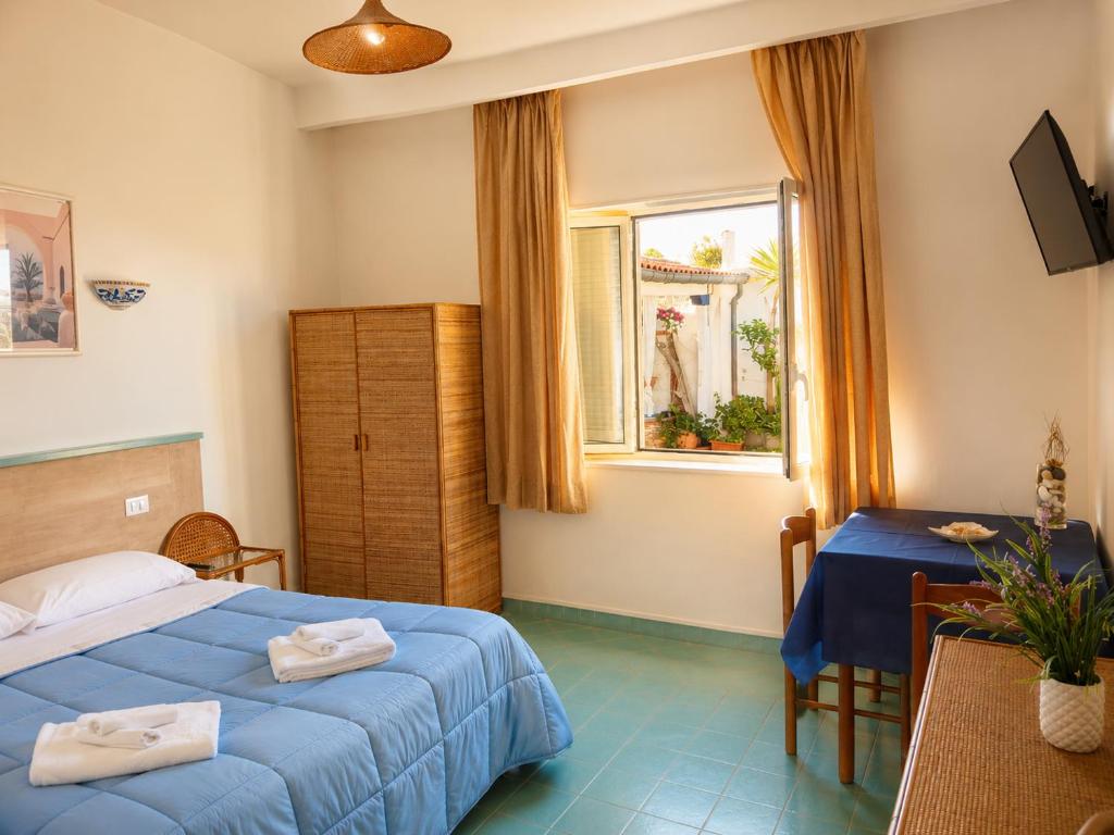 a hotel room with two beds and a window at Casa Vacanze Elianto in Anzio