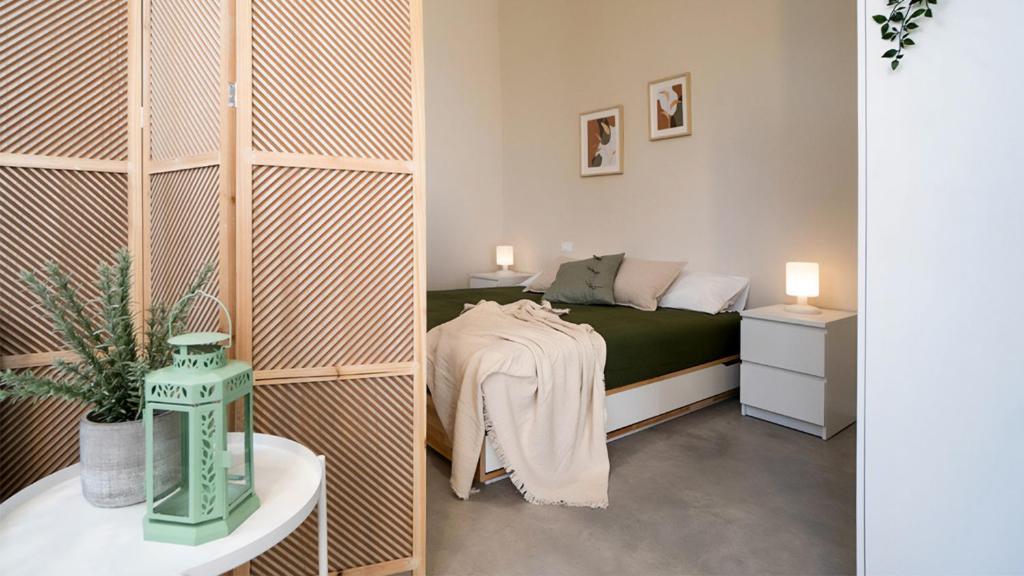 a small bedroom with a bed and a table at Casa del Falegname - Loft Abete con cucina in San Giovanni in Bosco