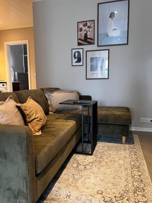 a living room with a couch and a table at East Apartment in Egilsstaðir