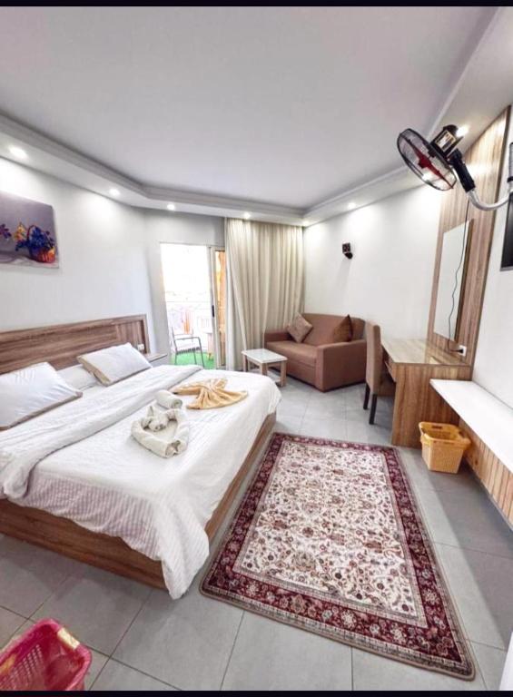 a bedroom with a bed and a living room at Domi Chalet in Hurghada