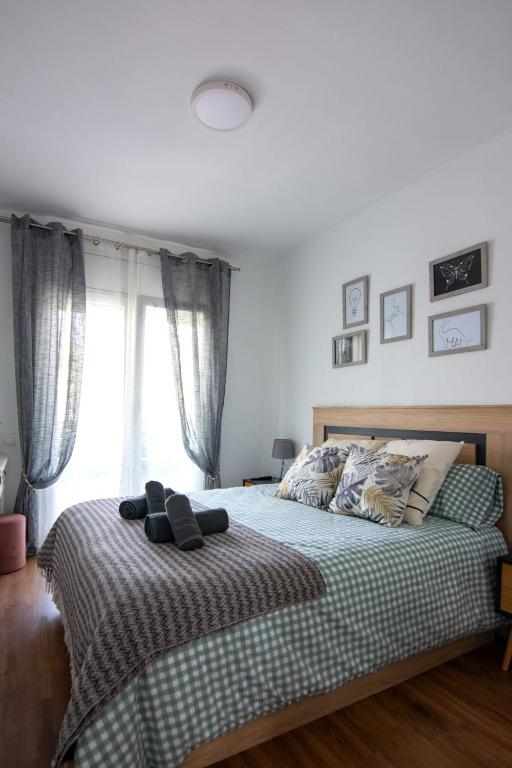 a bedroom with a bed and a window at El Racó de la Vero in Falset