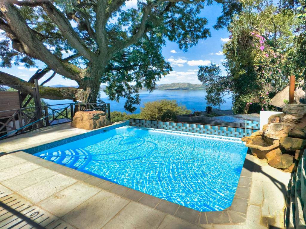a swimming pool with a view of the water at Harties Lake View in Hartbeespoort