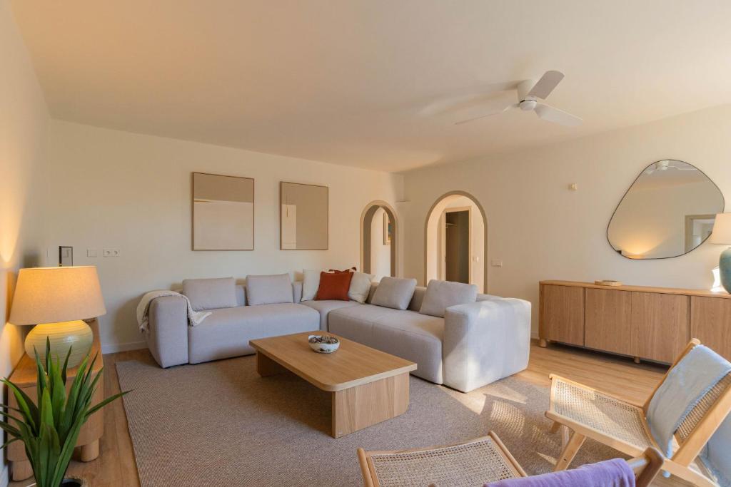 a living room with a couch and a table at Villa Can Ferrer in the centre of Cala dOr in Cacla D'or
