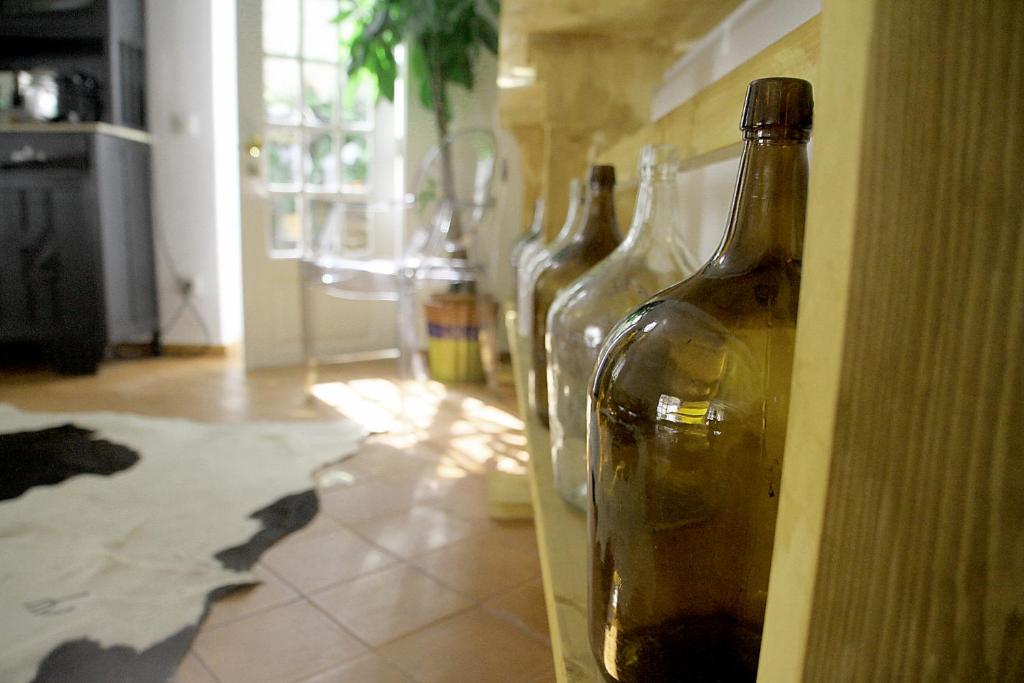 a row of wine bottles on a wall at Senhora do Cabo Meco Homy Holidays in Sesimbra