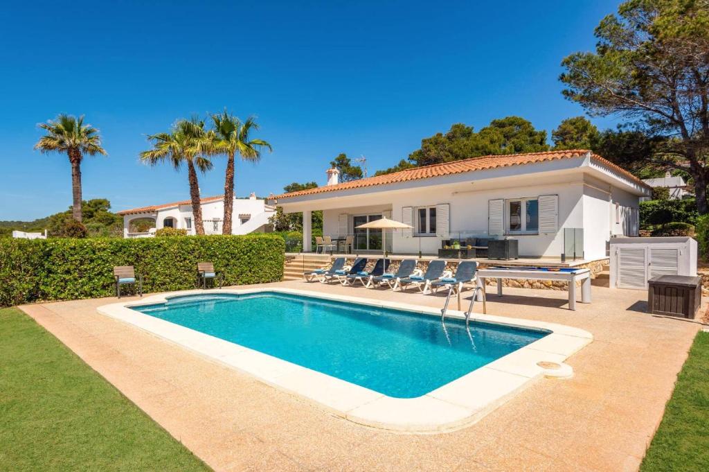 a swimming pool in front of a house at Villa Camomila Tomas by Villa Plus in Santo Tomás
