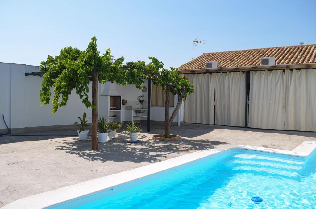 a swimming pool in the backyard of a house at Casa Mara in La Herrería