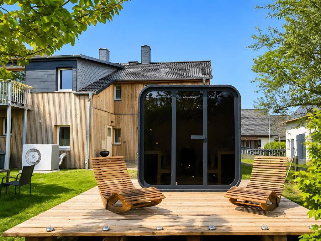 a pair of chairs sitting on a wooden deck at Urlaub auf dem Land in Triepkendorf