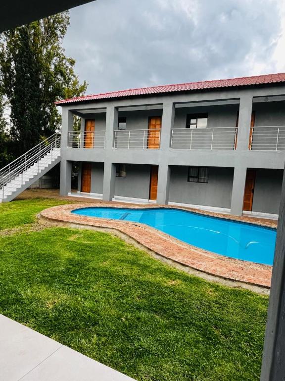 a house with a swimming pool in front of it at Rest Easy Guest House Pty Ltd Unit 5 in Boksburg