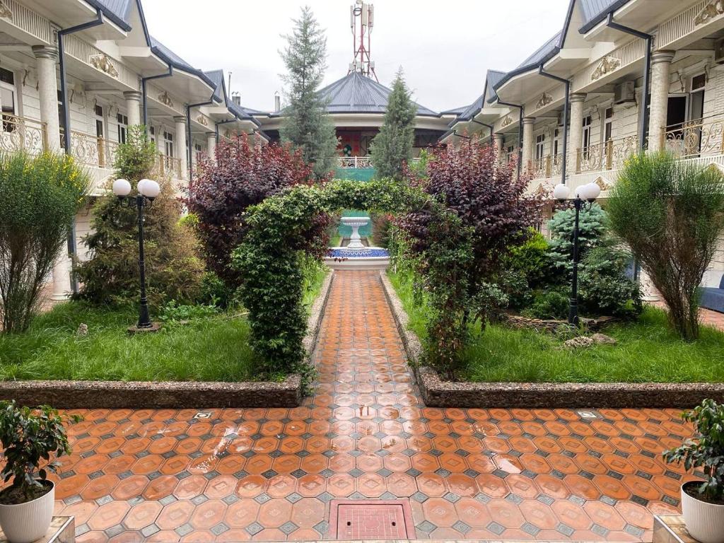 a brick walkway in front of a building at Shodlik Hostel in Andizhan