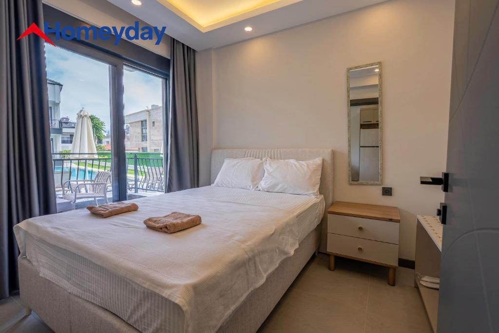 a bedroom with a bed and a window with a view at Whitestone Homes in Antalya