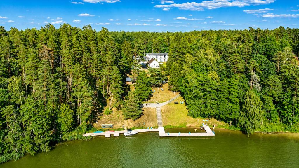an aerial view of a house in the middle of a lake at Ruciane Tarasy in Ruciane-Nida