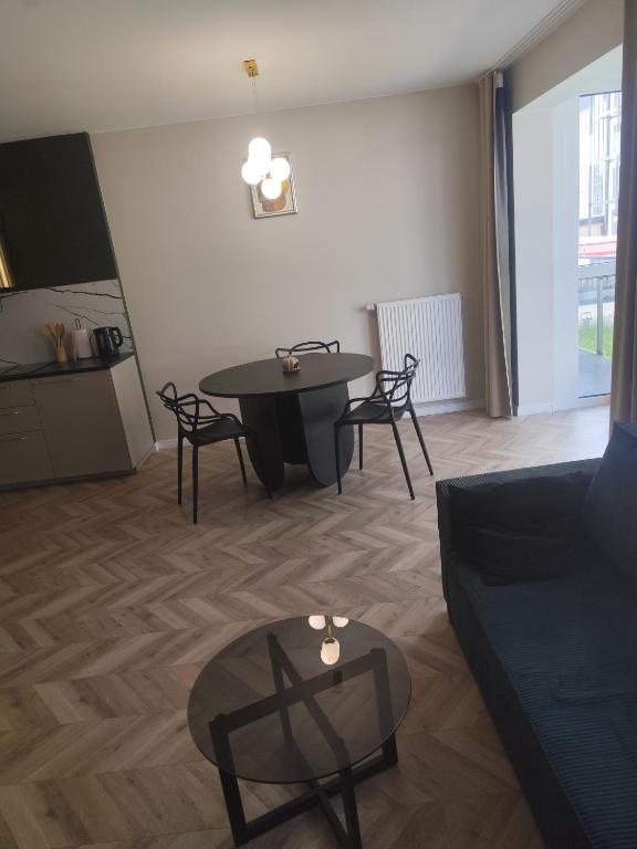 a living room with a table and chairs and a couch at Apartament Isabell in Busko-Zdrój