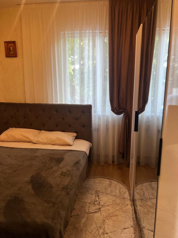 a bedroom with a bed in front of a window at Anna in Rivne