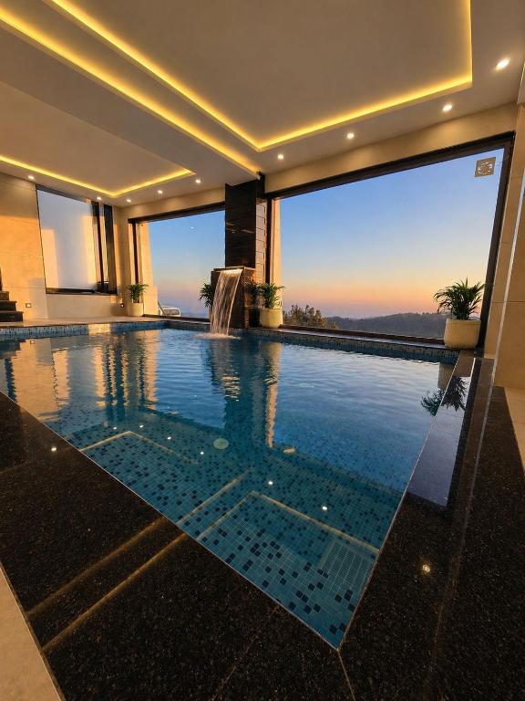 a swimming pool in a house with a view at Barog Heights in Barog