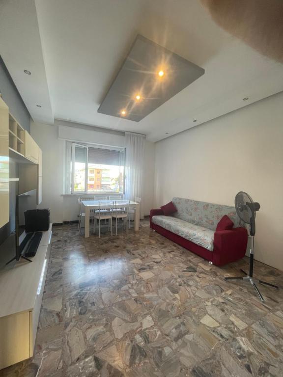 a living room with a couch and a table at Casa vacanza Dominga in Marotta