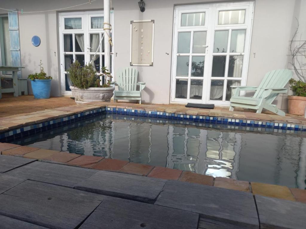 a swimming pool in front of a house at Oceanview Sunrise Beach Villa in Rocklands