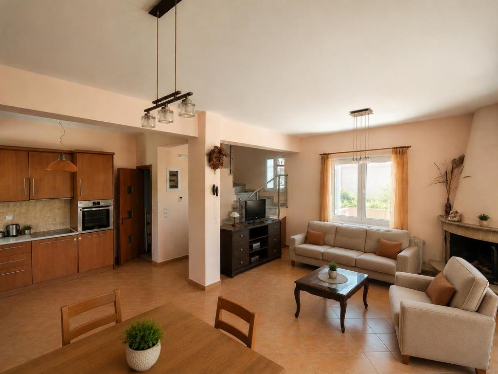 a living room with a couch and a table at Casa Rosa Ammoudia in Ammoudia