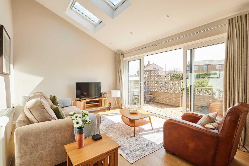 a living room with a couch and a tv at Host & Stay - Stille House in Beadnell