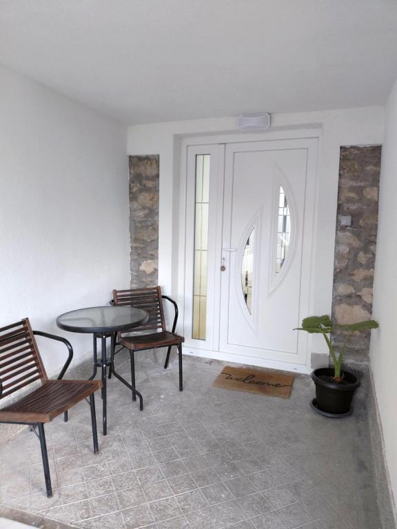 a room with a table and chairs and a door at Apartment Matej in Kruševo
