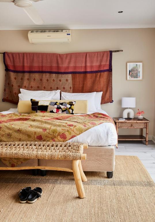 a bedroom with a large bed and a rug at THE BIG - Luxury Backpackers in Cape Town