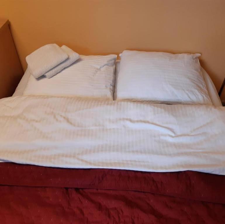 a white bed with two pillows on top of it at Forrent-ee in Pärnu