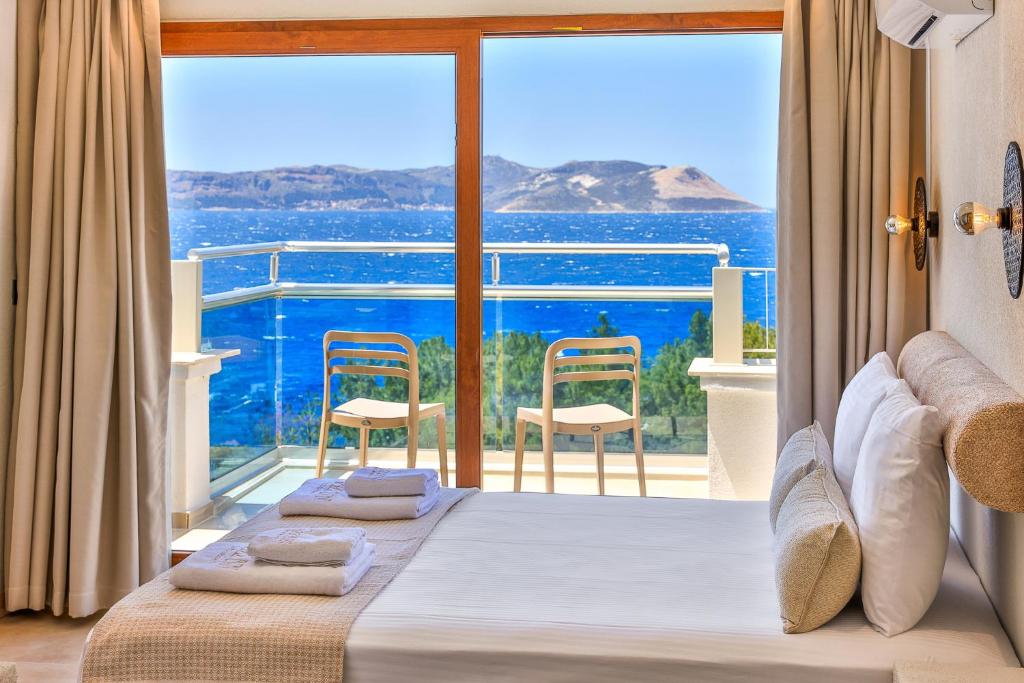 a bedroom with a bed and a view of the ocean at yazz inn in Kaş
