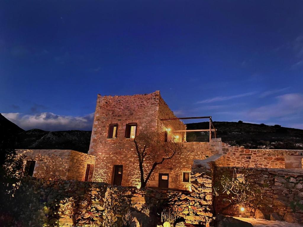 a stone building with a tree in front of it at Agrià XVII Mani Stone Tower in Kotráfion