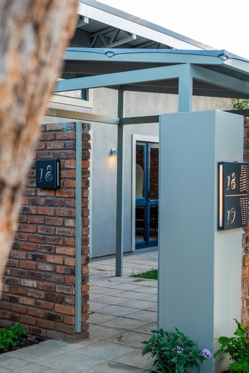 an entrance to a building with two signs on it at The Pods Victoria Falls in Victoria Falls