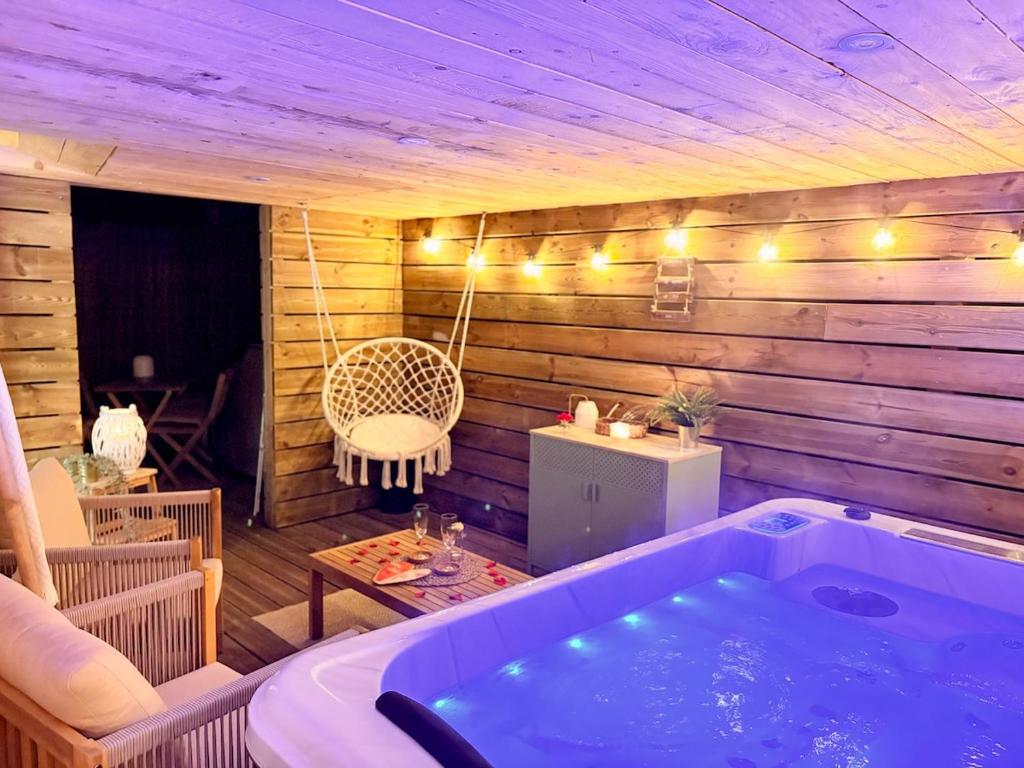 a jacuzzi tub in the middle of a room at La Chaumière des Marais Escapade romantique & jacuzzi privatif in La Chapelle-des-Marais
