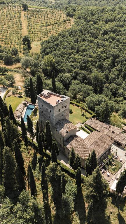 an aerial view of a house with a pool at Castello Di Tornano Wine Relais in Gaiole in Chianti