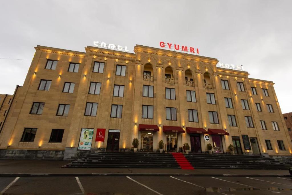 a large building with a sign on top of it at Gyumri Hotel in Gyumri