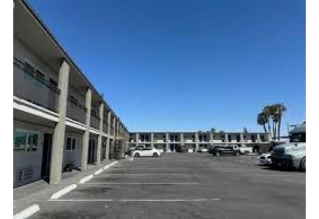 a parking lot in front of a large building at Studio 6 North Las Vegas, NV in Las Vegas