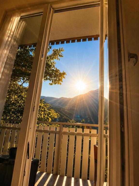 a view of the sun from a balcony at Appartment Lodged Mamma Maria in Mattarello