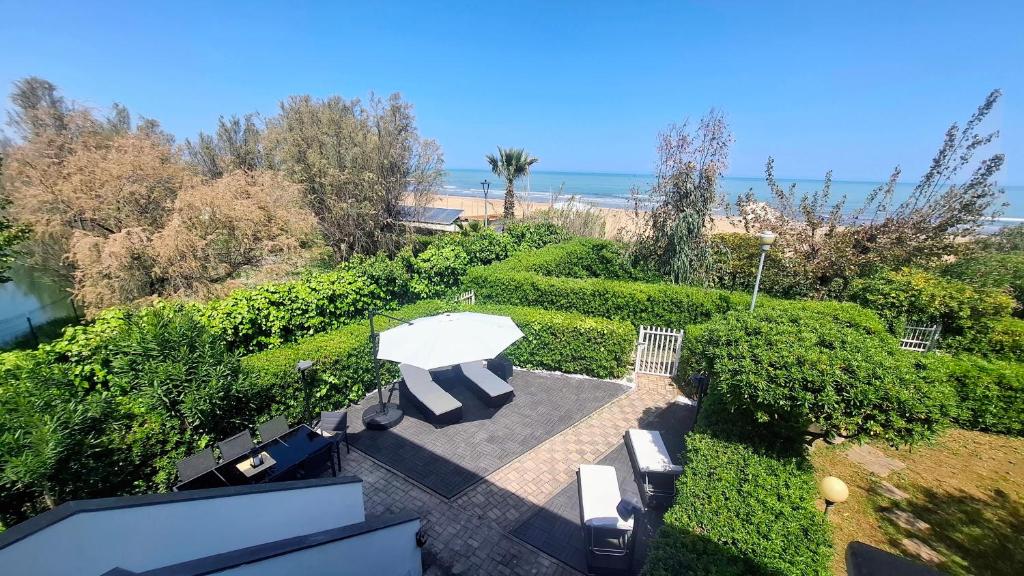an overhead view of a patio with a table and benches at Casa Katarina Beach Apartment in Silvi Marina