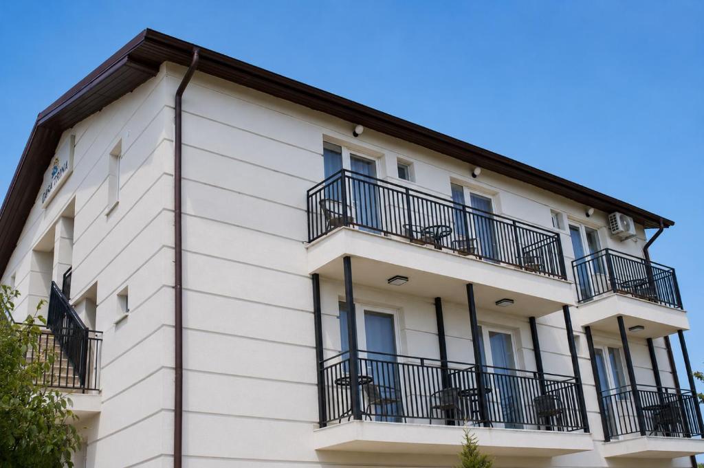 a white building with balconies on it at Casa Irina 2Mai in 2 Mai