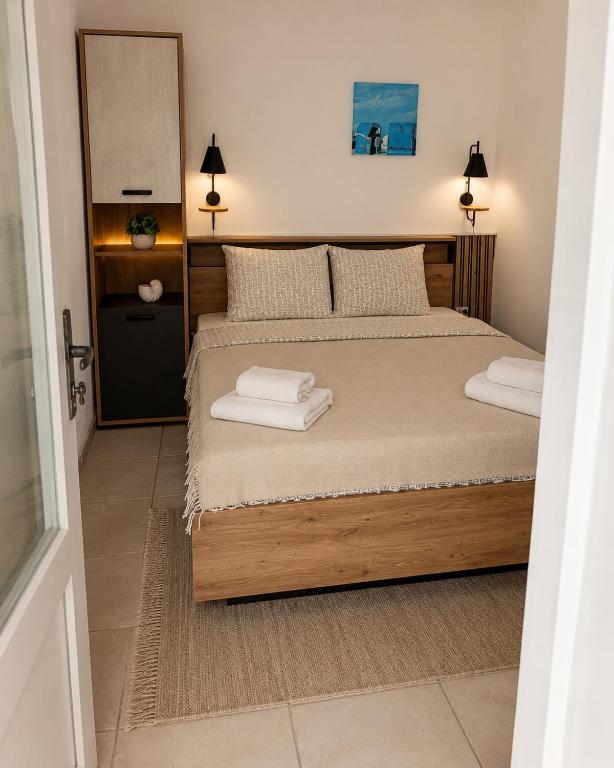 a bedroom with a bed with two towels on it at KRAPEC Beach in Krapets