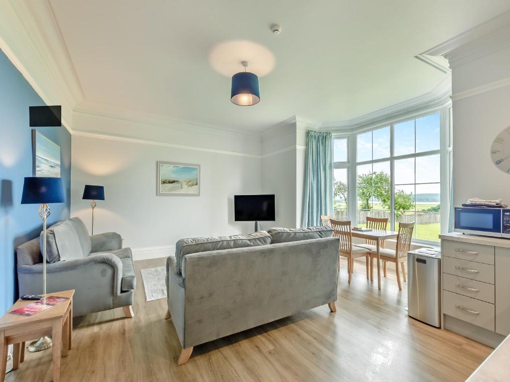 a living room with a couch and a table at Silverdale Apartment in Lindale
