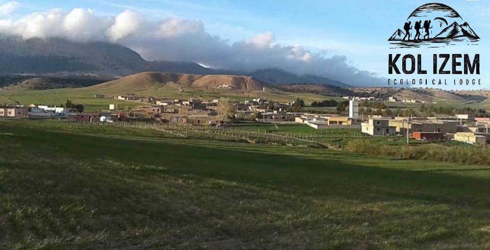 a view of a town with mountains in the background at Kol izem in Ksar el Kbir