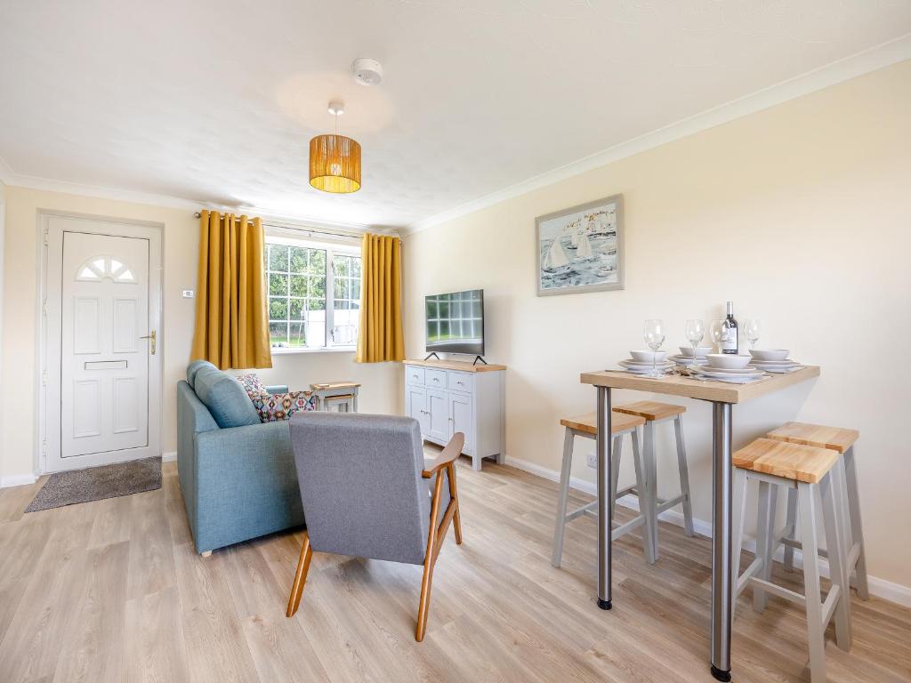 a kitchen and living room with a table and a couch at Oaks - Uk47372 in Burgh le Marsh