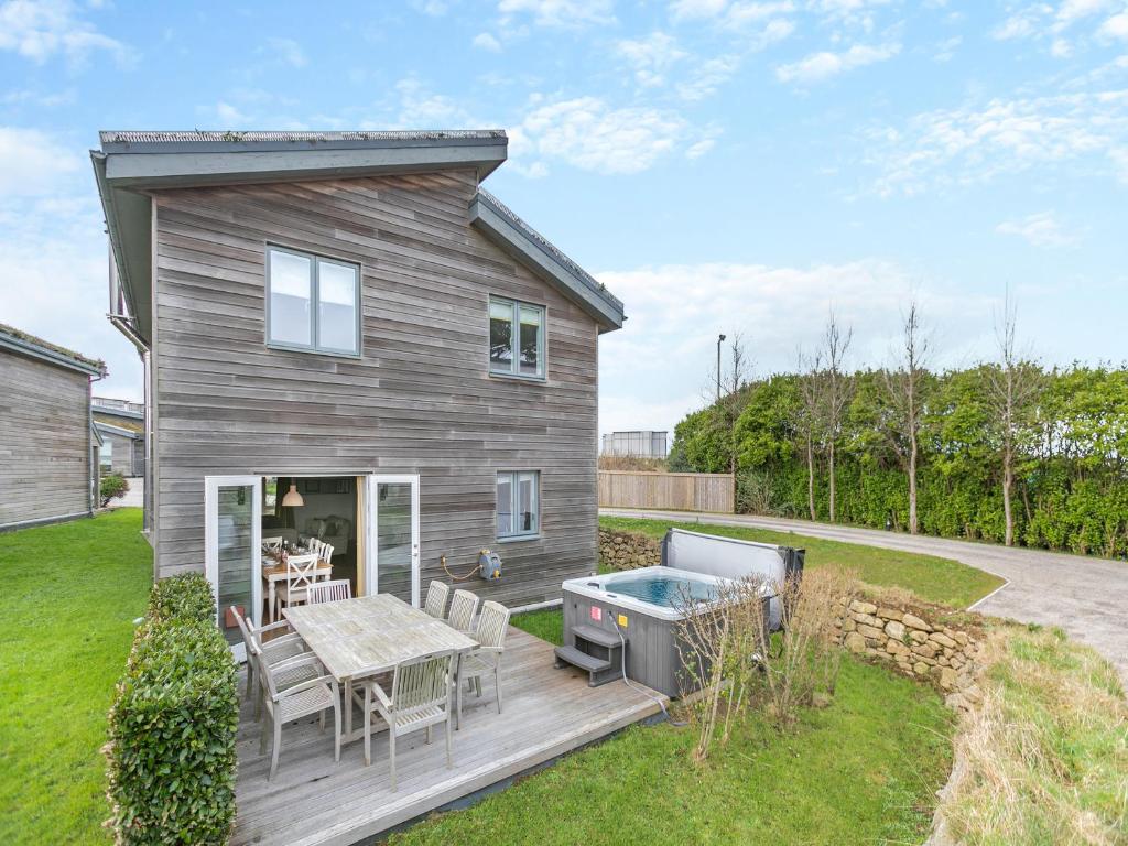 a house with a deck with a hot tub at Lodge 74 Una in Carbis Bay