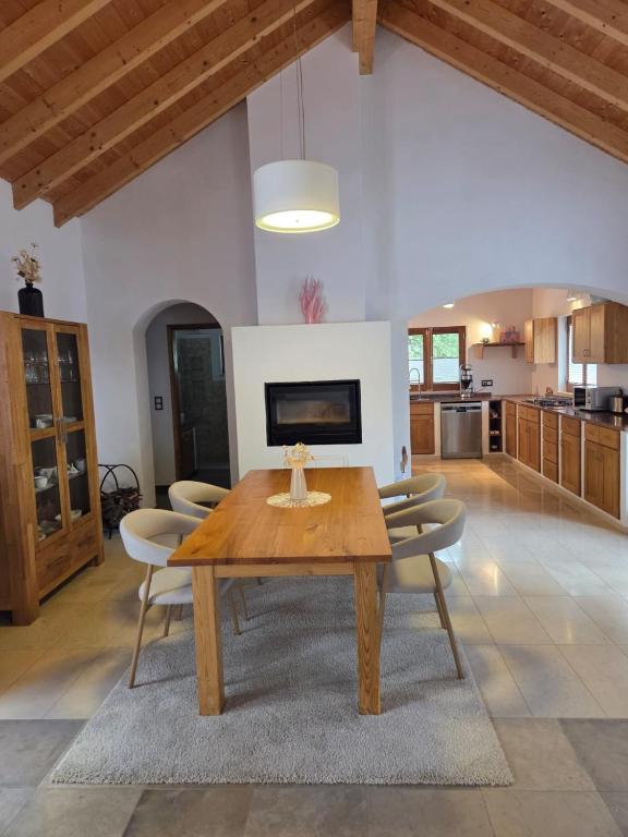 a dining room with a wooden table and chairs at Casinha Laranja in Monchique