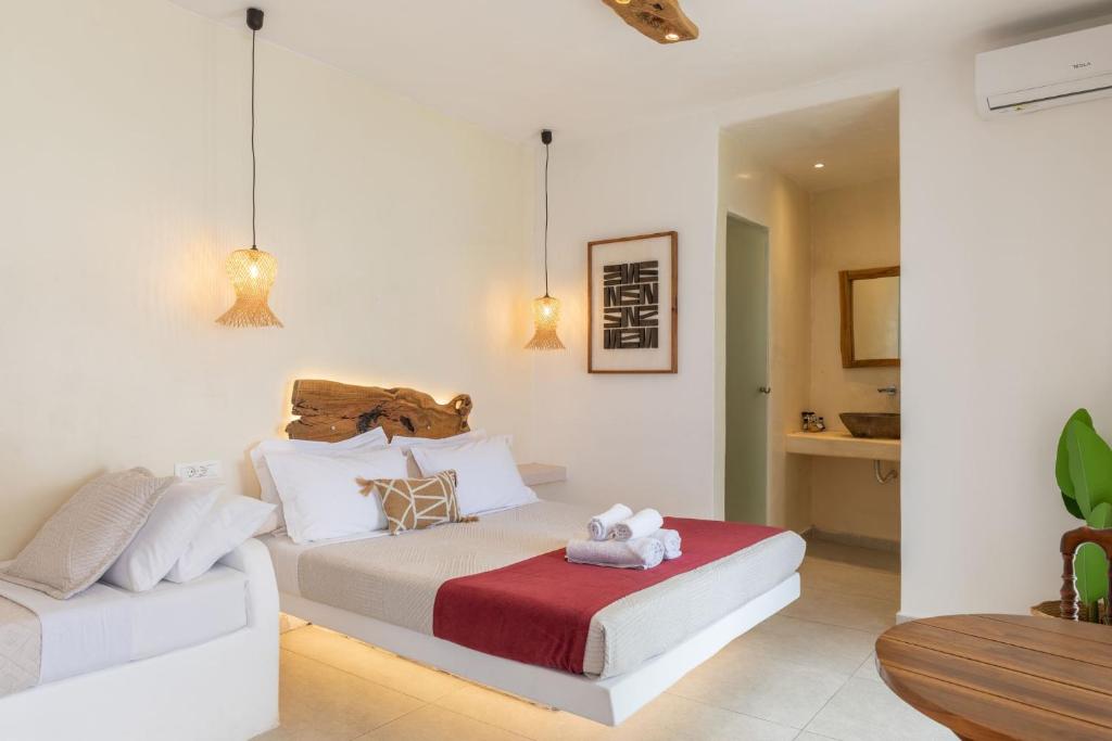 a bedroom with a bed and a couch at Casa Philippi Suites in Mikonos